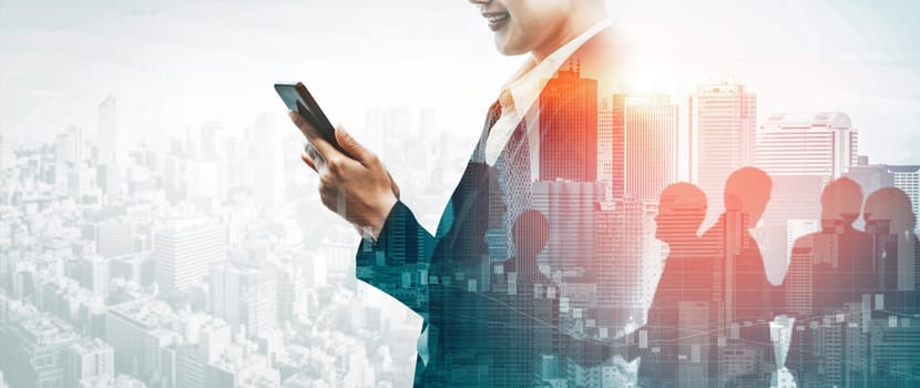 Double Exposure Image of Business Communication Network Technology Concept - Business people using smartphone or mobile phone device on modern cityscape background. uds