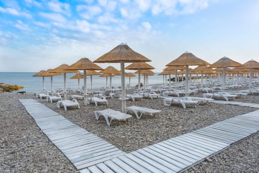 Beach umbrellas from straw in the resort village of Nebug, Krasnodar Territory, Russia..