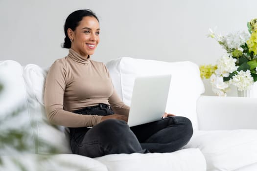 African-American woman using laptop computer for crucial work on internet. Secretary or online content writing working at home.