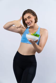 Full body length gaiety shot athletic and sporty young woman with healthy vegan food in standing posture on isolated background. Healthy active and body care by vegetarian lifestyle.