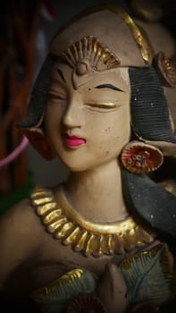 Beautiful artistic statue of a Balinese or javanese dancer used as garden decoration, javanese gnome indonesia asian garden statue