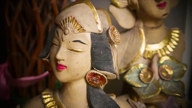 Beautiful artistic statue of a Balinese or javanese dancer used as garden decoration, javanese gnome indonesia asian garden statue