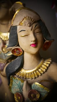 Beautiful artistic statue of a Balinese or javanese dancer used as garden decoration, javanese gnome indonesia asian garden statue
