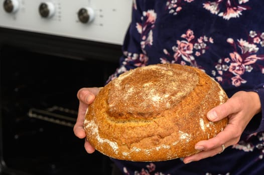 appetizing homemade whole grain bread in the hands of a woman 6