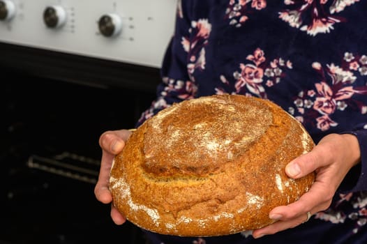 appetizing homemade whole grain bread in the hands of a woman 7