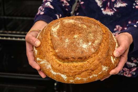 appetizing homemade whole grain bread in the hands of a woman 9