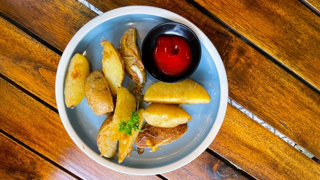 Top View Baked potato wedges with shredded onion and herbs and tomato sauce platted homemade organic vegetable vegan vegetarian potato wedges snack food meal