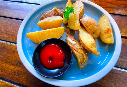 Top View Baked potato wedges with shredded onion and herbs and tomato sauce platted homemade organic vegetable vegan vegetarian potato wedges snack food meal