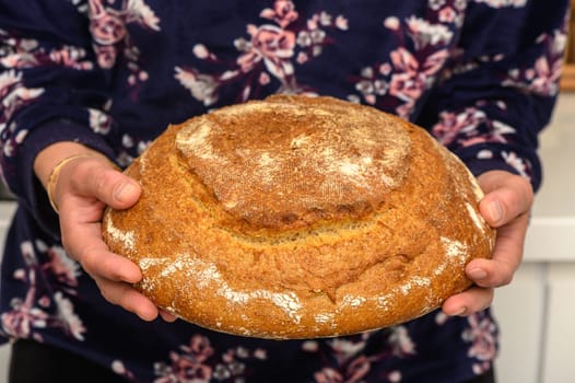 appetizing homemade whole grain bread in the hands of a woman 4