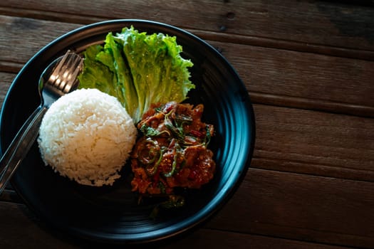 Stir fried beef with basil, chopped chili and garlic served with steam rice.