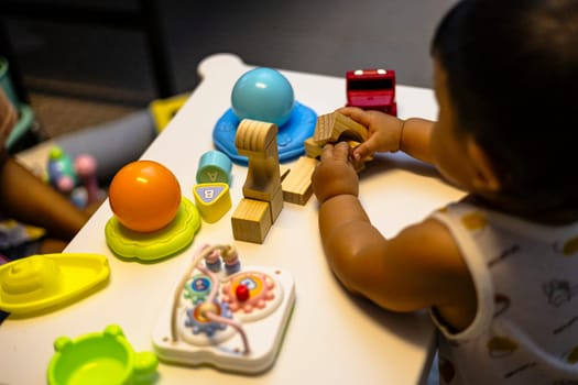 Asian baby Toddler playing colorful blocks.