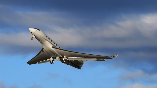 Payerne Switzerland January 15, 2024: A personal aircraft, the Gulfstream G650, rises against a dynamic cloud canvas, providing ample copy space for text or branding.