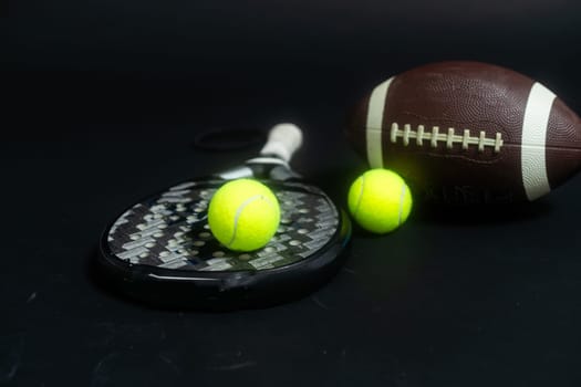 Sports equipment, rackets and balls on black background. Horizontal education and sport poster, greeting cards, headers, website. High quality photo
