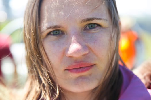 A true face of a viking woman with blue eyes, freckles and blond hair