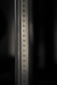 Big metal ruler on a dark background