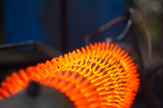 Red-hot spiral of nichrome thread on a metal pipe