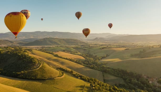 A breathtaking view of colorful hot air balloons soaring over a picturesque historic village nestled among lush greenery and mountains at sunrise.