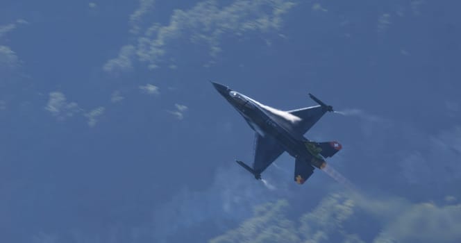Mollis Switzerland August 19 2023: Dynamic image capturing a military fighter jet in full flight with a beautiful blue sky backdrop