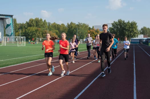 Group of young athlete runnner are training at the stadium outdoors