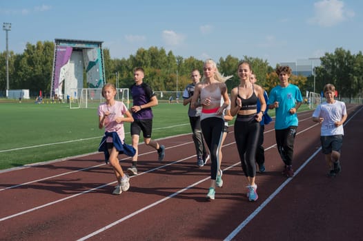 Group of young athlete runnner are training at the stadium outdoors