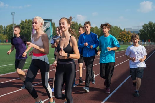 Group of young athlete runnner are training at the stadium outdoors