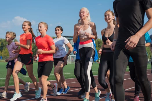 Group of young athlete runnner are training at the stadium outdoors