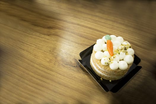 Carrot cake on wooden table. No people