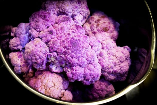 Raw purple cauliflower in a saucepan. No people