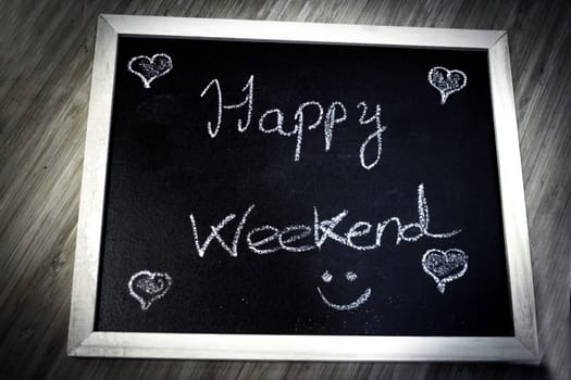 Happy weekend written with chalk. No copy space