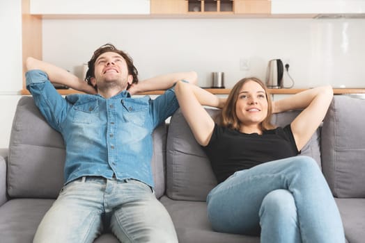 Young happy couple in living room. Couple bought their own flat