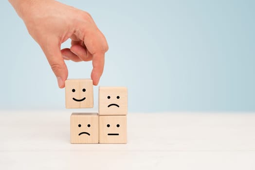Wooden cube block, smile and sad emotions. Different emotions concept