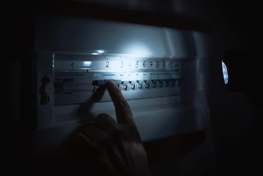 Investigate a home fuse box during a power outage. Blackout concept