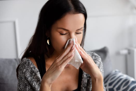 Sick woman blowing her nose. Woman caught cold.