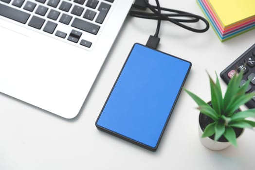 External backup disk, USB hard drive connected to laptop.