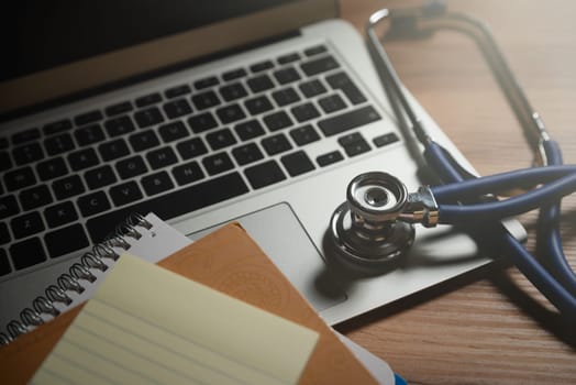Doctor workplace with a stethoscope and laptop. Telehealth concept