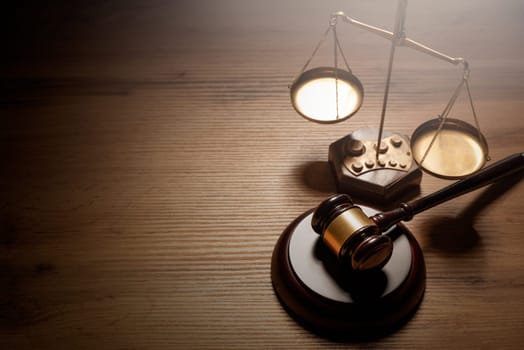 Judge gavel and weight scale on wooden table, justice and law concept