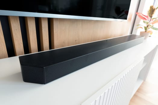 Soundbar device in modern living room. Audio equipment concept