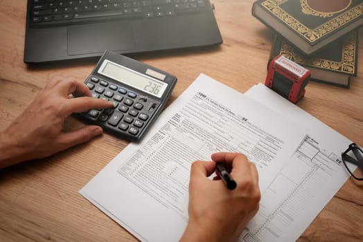 Man filling US tax forms, individual income tax return form