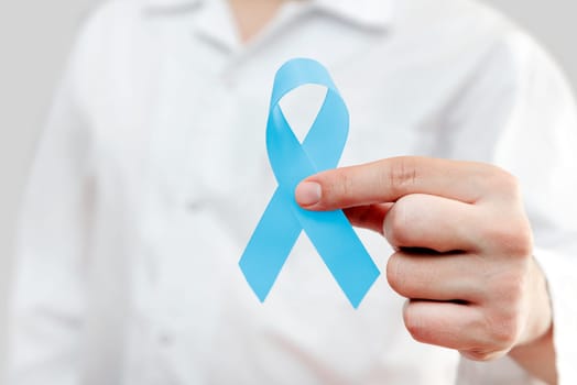 Man holding prostate cancer awareness ribbon. National cancer survivors month.