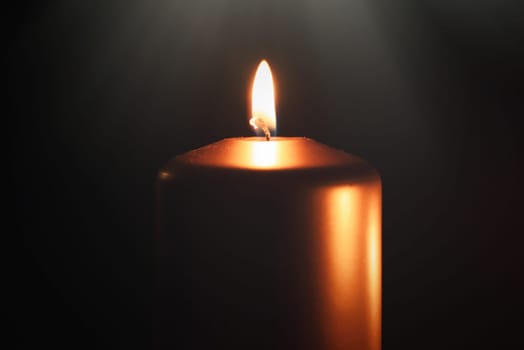 Funeral symbol with burning candle in darkness. Memorial composition