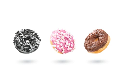 Delicious donut on white background. Mix of flying multicolored doughnuts