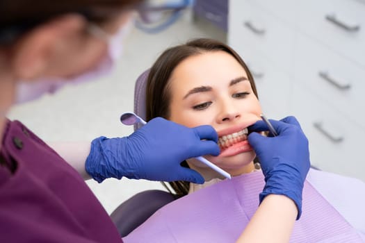 Dentist checking patients bite in a dental clinic. Teeth care concept
