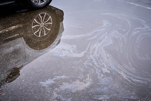 Engine oil stains of car. Leak under the car when the car is park.