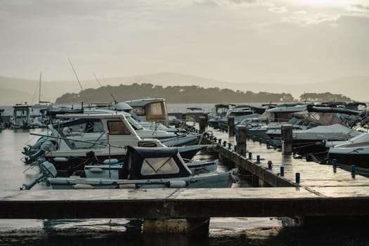 Old town motor boats moored in marina of Biograd na Moru of Croatia at sunset