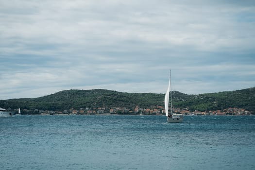 Modern boat sailing near shore, central marina of Biograd na Moru of Croatia