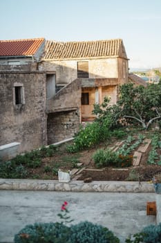 Old stone street of Biograd na Moru port in Croatia, sunset view of houses and garden