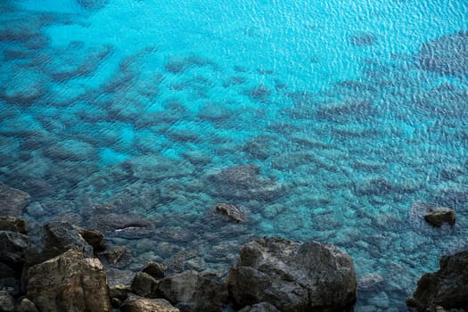 Top view of rocky beach with clear turquoise water, Cape Greco National Park, Cyprus