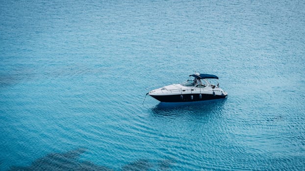 Modern yacht sailing on turquoise clear sea water in Cape Greco National Park, Cyprus