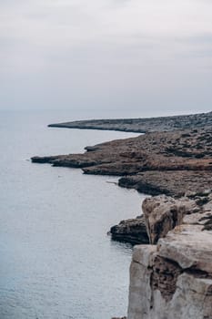 Rocks and green plants on sea beach in Cape Greco National Park, Cyprus