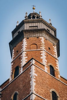 Corpus Christi Basilica brick red tower with arches on windows, Gothic church and landmark in Krakow, Poland